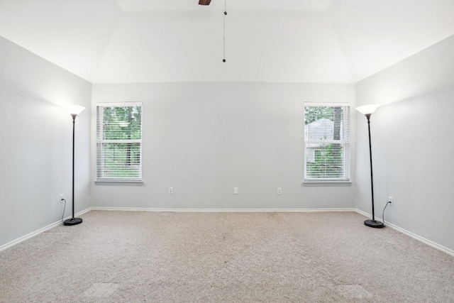 unfurnished room with light carpet, ceiling fan, and vaulted ceiling