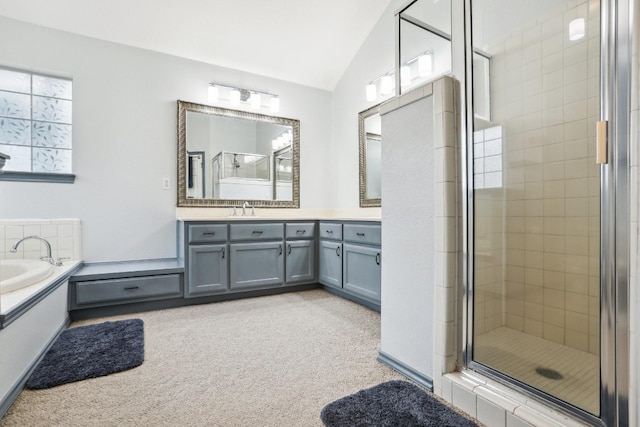 bathroom with shower with separate bathtub, lofted ceiling, and vanity