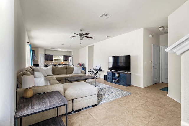 living room featuring ceiling fan and light tile patterned floors