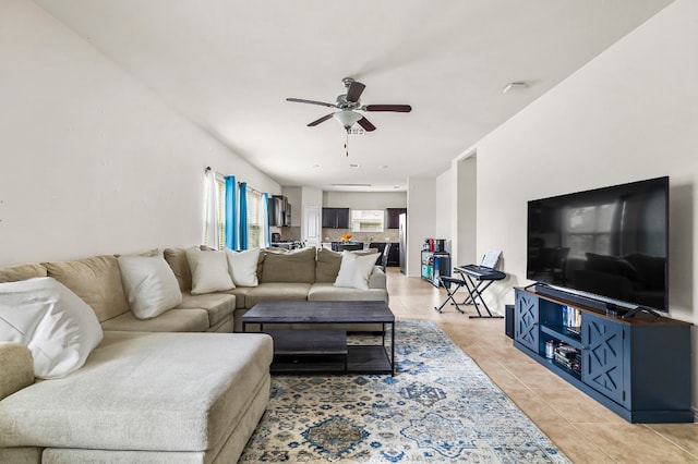 living room with ceiling fan and light tile patterned floors