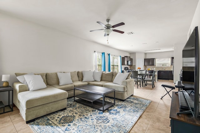 living room featuring a healthy amount of sunlight, ceiling fan, and light tile patterned floors