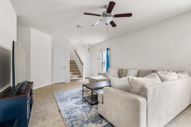 living room with ceiling fan and light tile patterned floors