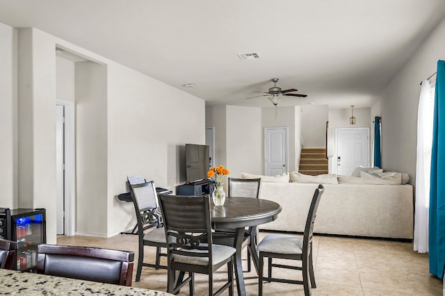 tiled dining room featuring ceiling fan