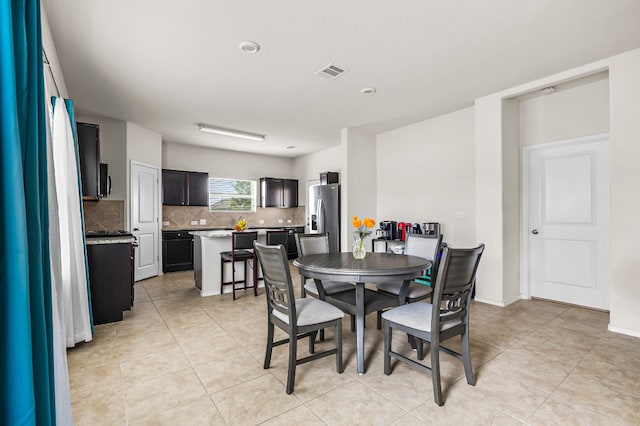 dining space featuring light tile patterned floors