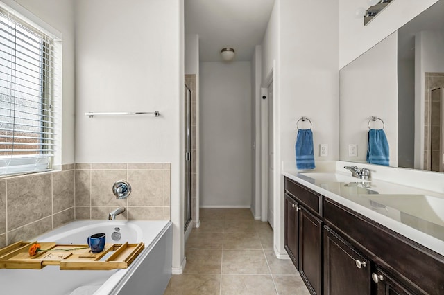 bathroom featuring a wealth of natural light, vanity, tile patterned floors, and independent shower and bath