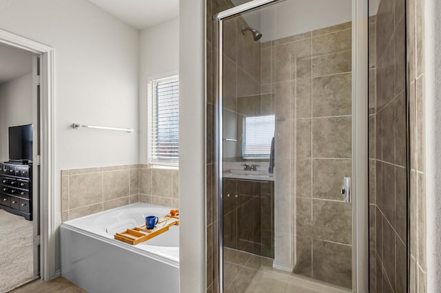 bathroom featuring tile patterned flooring and shower with separate bathtub