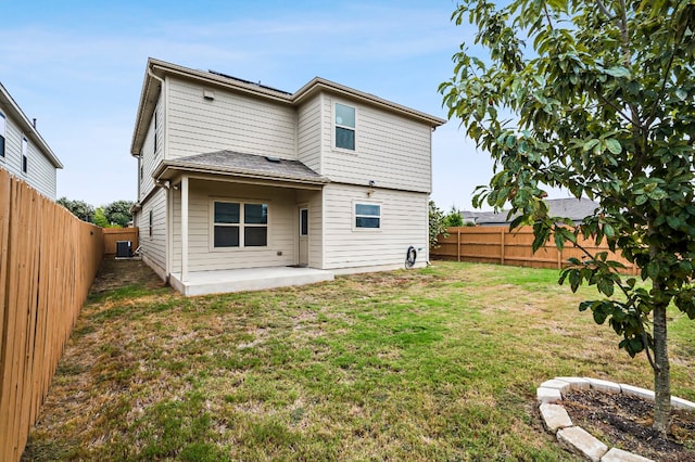 rear view of property featuring central air condition unit, a lawn, and a patio