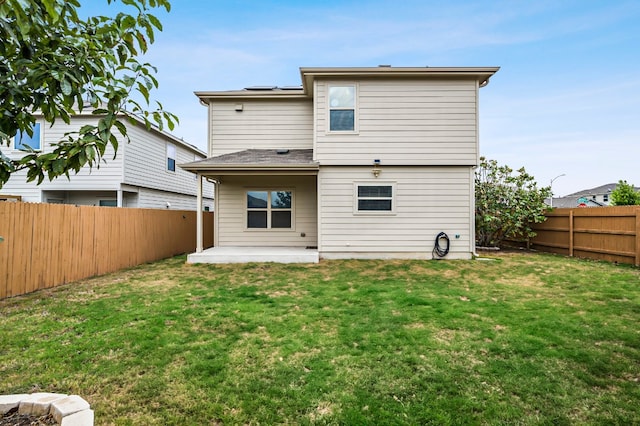 rear view of house with a patio and a yard