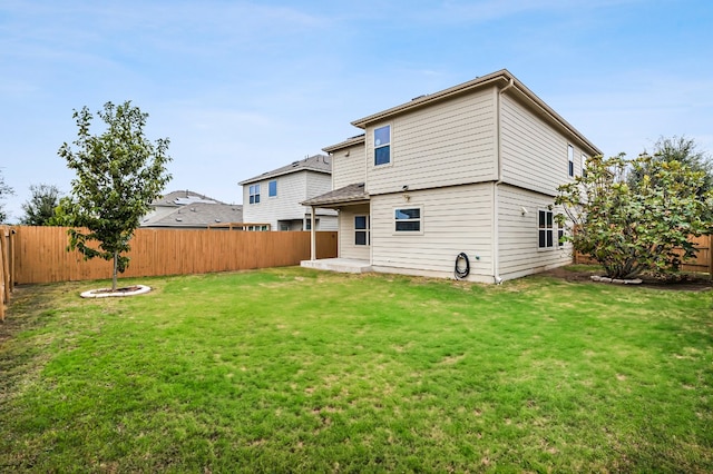 back of property featuring a lawn