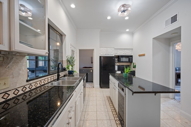 kitchen with black appliances, sink, a kitchen breakfast bar, crown molding, and white cabinetry