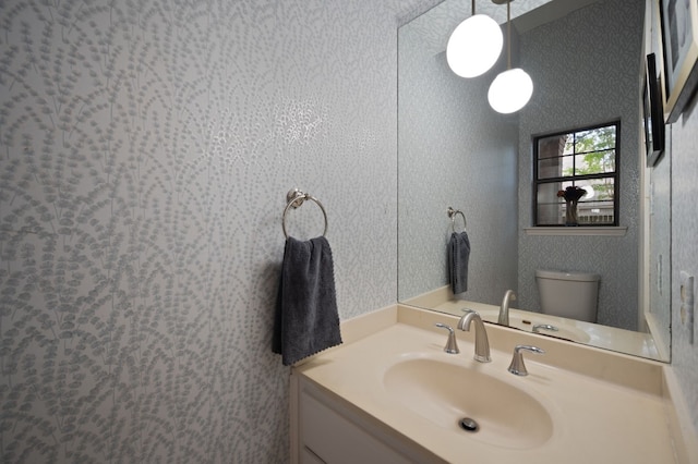 bathroom featuring vanity and toilet