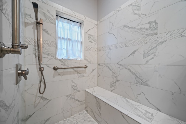 bathroom with a tile shower