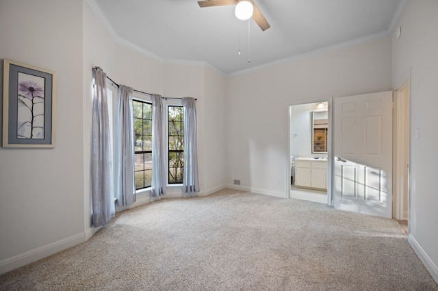 carpeted spare room with ceiling fan and crown molding