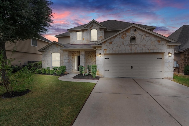 view of front of property featuring a yard and a garage