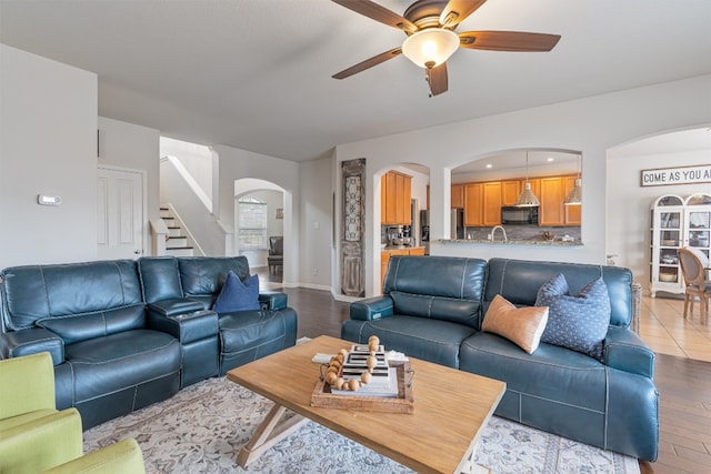 living room featuring light hardwood / wood-style flooring and ceiling fan