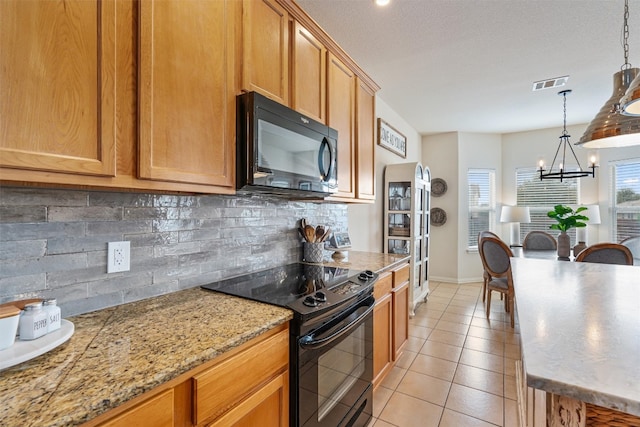 kitchen featuring a notable chandelier, backsplash, decorative light fixtures, light tile patterned flooring, and black appliances