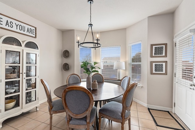201 Prospector Ln, Liberty Hill, TX 78642 - dining room featuring light tile patterned floors, a textured ceiling, and a notable chandelier