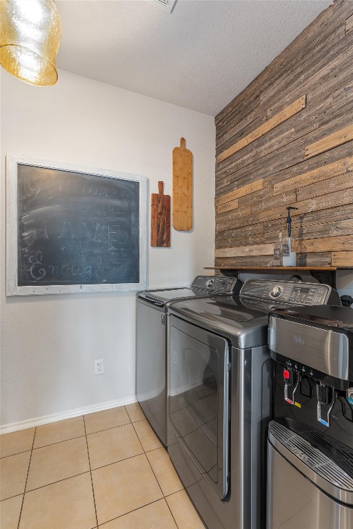 laundry room with light tile patterned flooring and separate washer and dryer