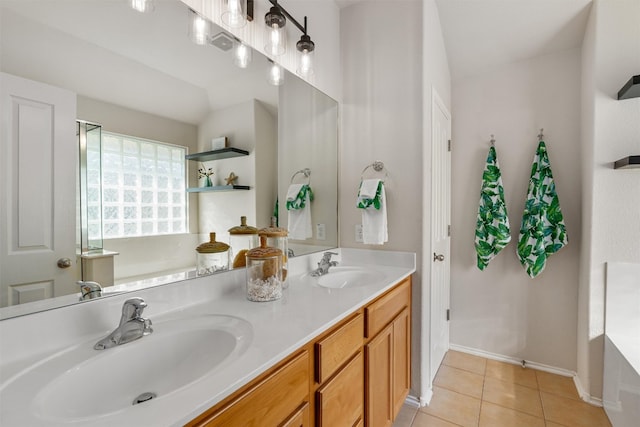 bathroom with tile patterned flooring, vanity, and a bathing tub