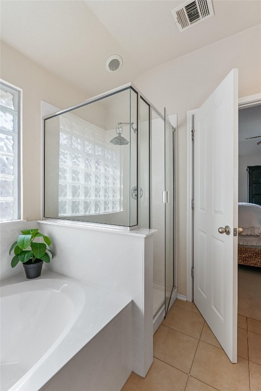 bathroom with ceiling fan, tile patterned flooring, and shower with separate bathtub