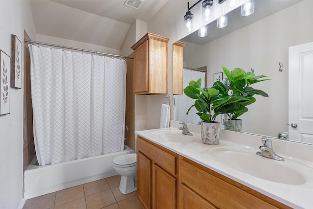 full bathroom featuring toilet, tile patterned flooring, vanity, and shower / tub combo with curtain