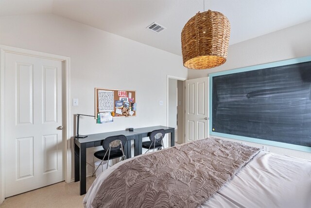 carpeted bedroom with lofted ceiling