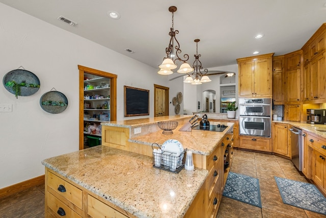 kitchen with appliances with stainless steel finishes, a large island, light stone countertops, and hanging light fixtures