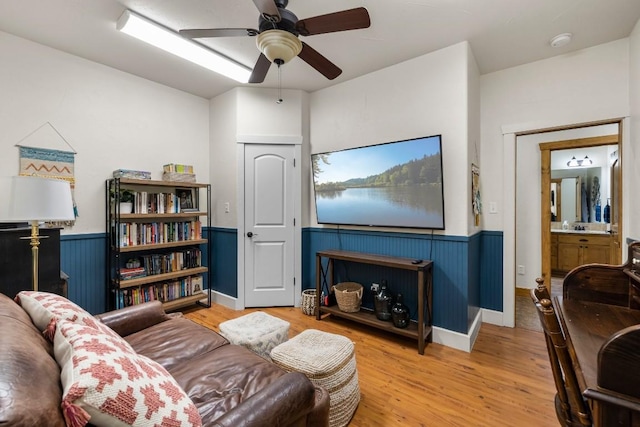 living room with hardwood / wood-style flooring and ceiling fan