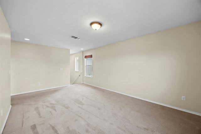 unfurnished room with light carpet