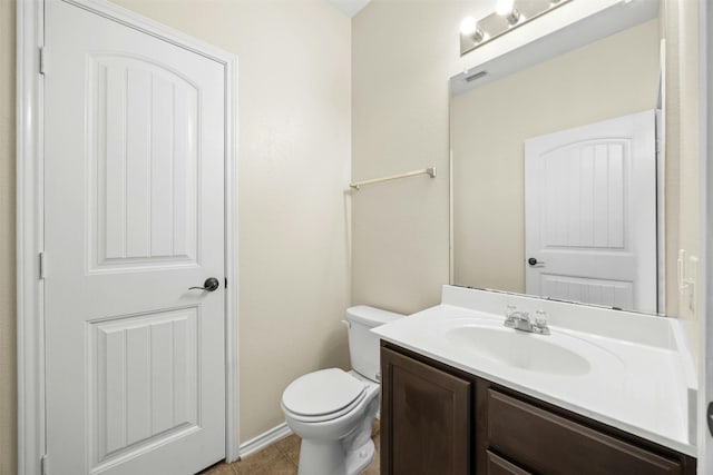 bathroom featuring vanity, tile patterned floors, and toilet