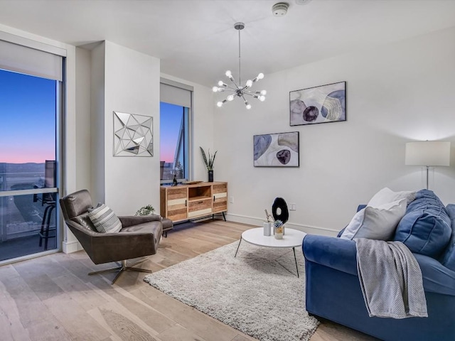 living room with hardwood / wood-style flooring and a notable chandelier