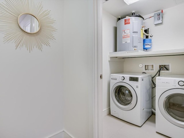 clothes washing area with water heater, separate washer and dryer, and light tile patterned floors