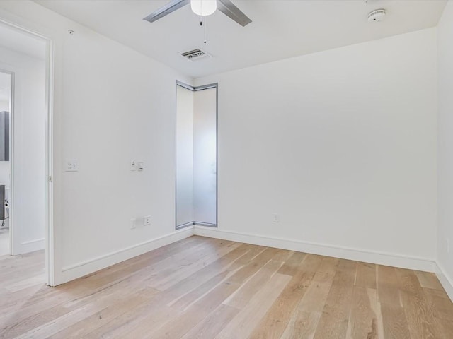 empty room with ceiling fan, baseboards, visible vents, and light wood-type flooring