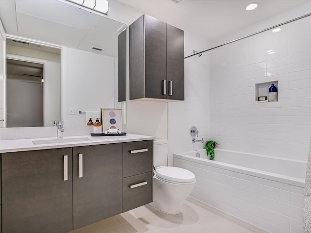 full bathroom with vanity, toilet, tiled shower / bath combo, and tile patterned flooring