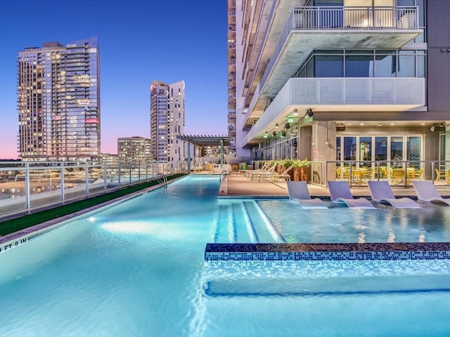 pool at dusk with a patio