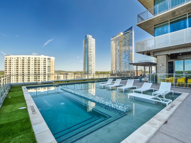 pool featuring a city view and a patio area