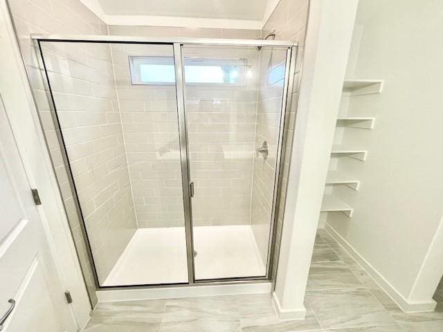 bathroom with a shower with shower door