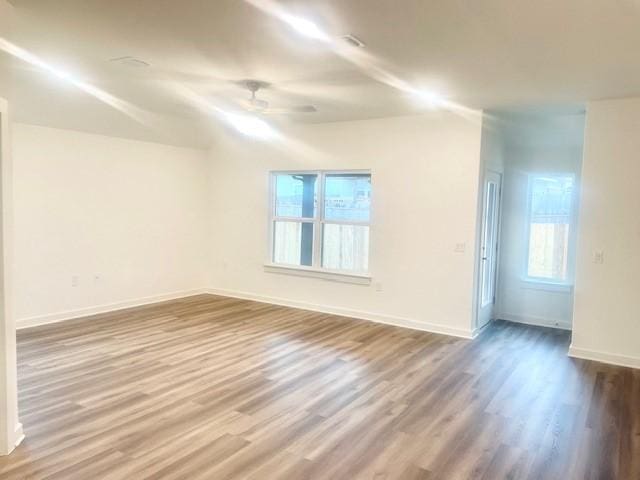 unfurnished room with hardwood / wood-style flooring and ceiling fan