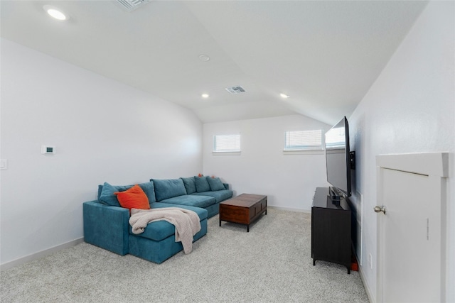 carpeted living room with lofted ceiling