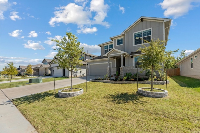 view of front of home with fence, concrete driveway, a front lawn, a garage, and board and batten siding