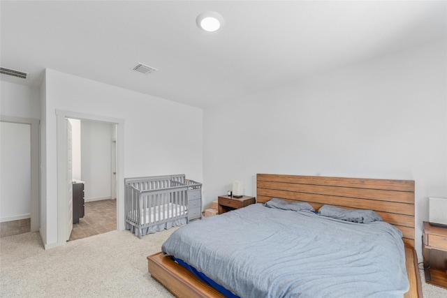 bedroom featuring light colored carpet