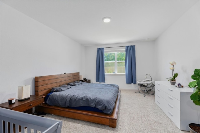 bedroom featuring light colored carpet