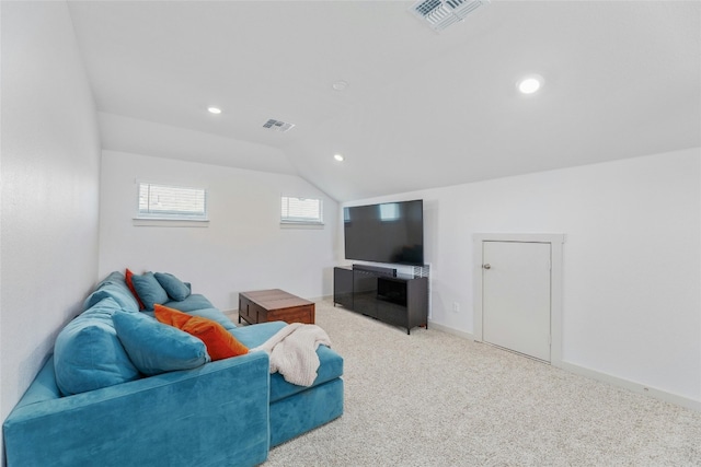 carpeted living room with lofted ceiling