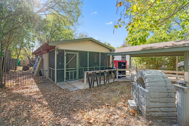 back of house featuring a patio area and a sunroom