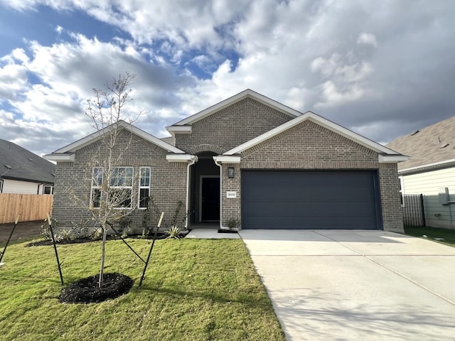 view of front of home featuring a garage and a front yard