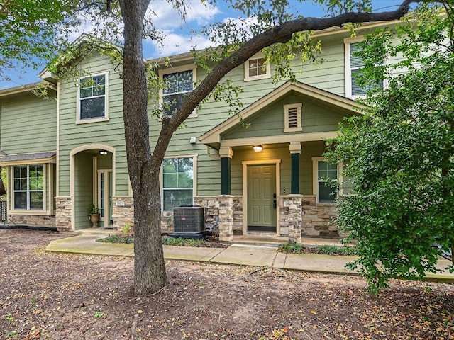 craftsman-style home with a porch and cooling unit