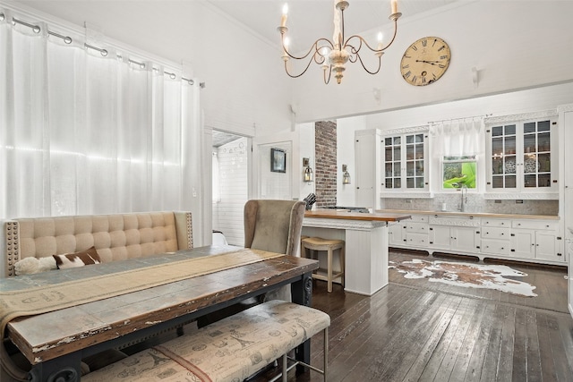 dining room featuring ornamental molding, dark hardwood / wood-style flooring, and a healthy amount of sunlight