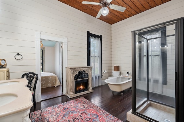 bathroom featuring plus walk in shower, wooden walls, hardwood / wood-style floors, and wooden ceiling