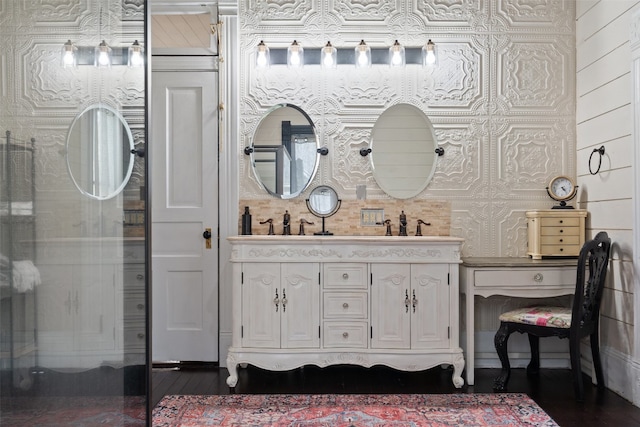 bathroom featuring hardwood / wood-style floors, vanity, and wooden walls