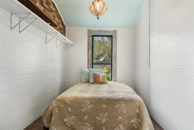 bedroom featuring brick wall